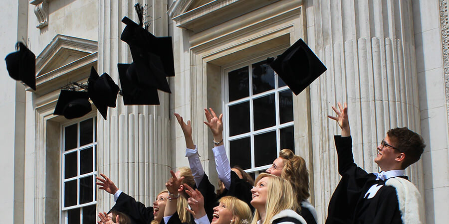 New graduates throwing mortarboards