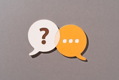 Two speech bubbles, one with a question mark and one with an elipsis.