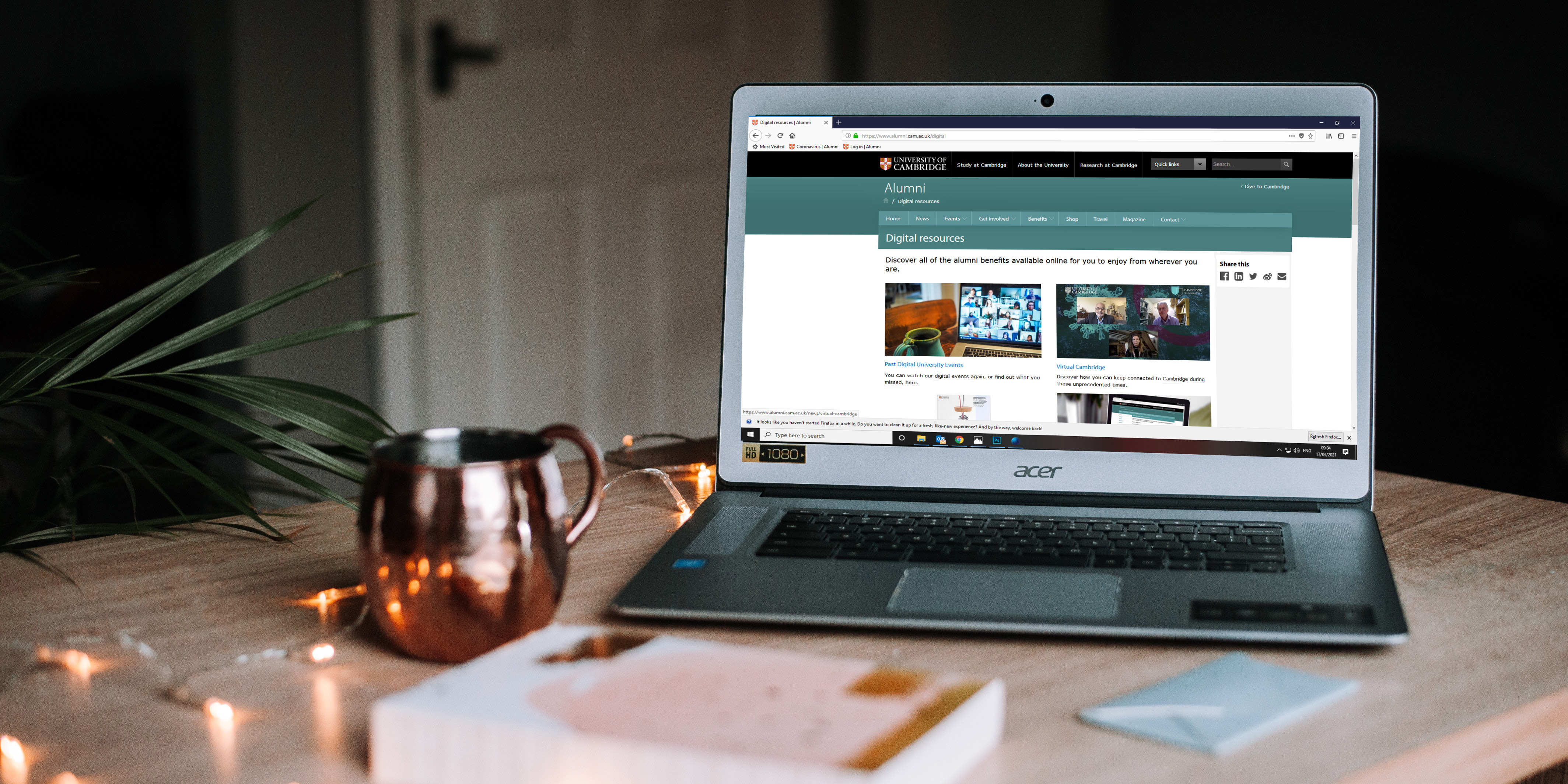 A laptop with the Alumni website on the screen