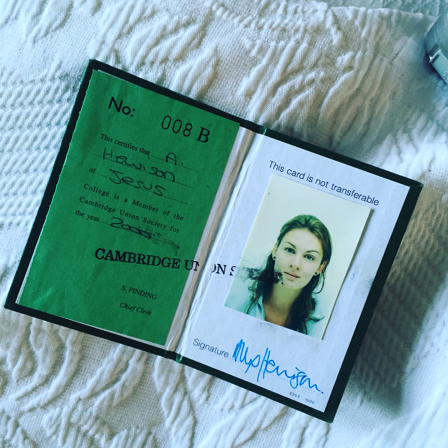 Open book containing a Cambridge Union membership card including headshot of Ali Draycott