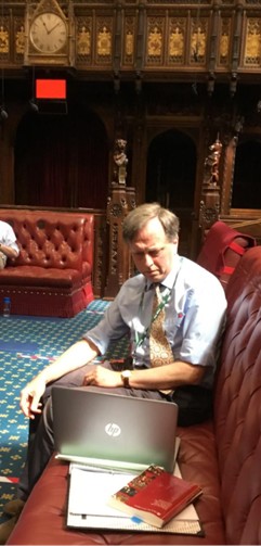 photograph of andrew makower sat on bench in parliament
