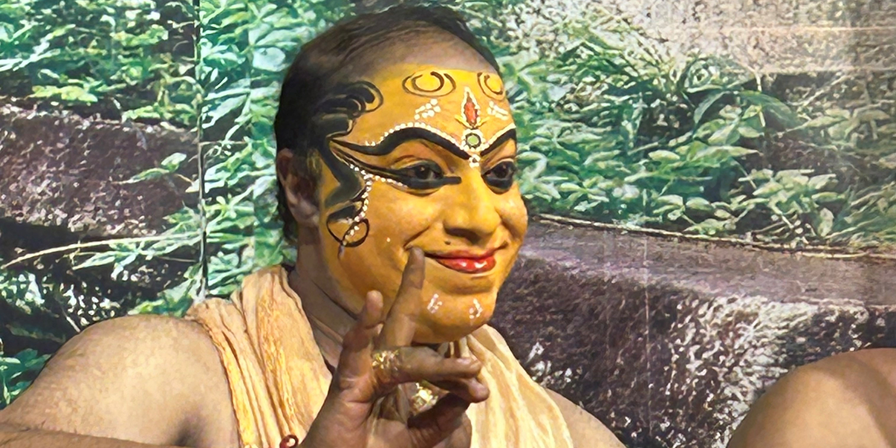 Tribe member with full traditional wear and makeup