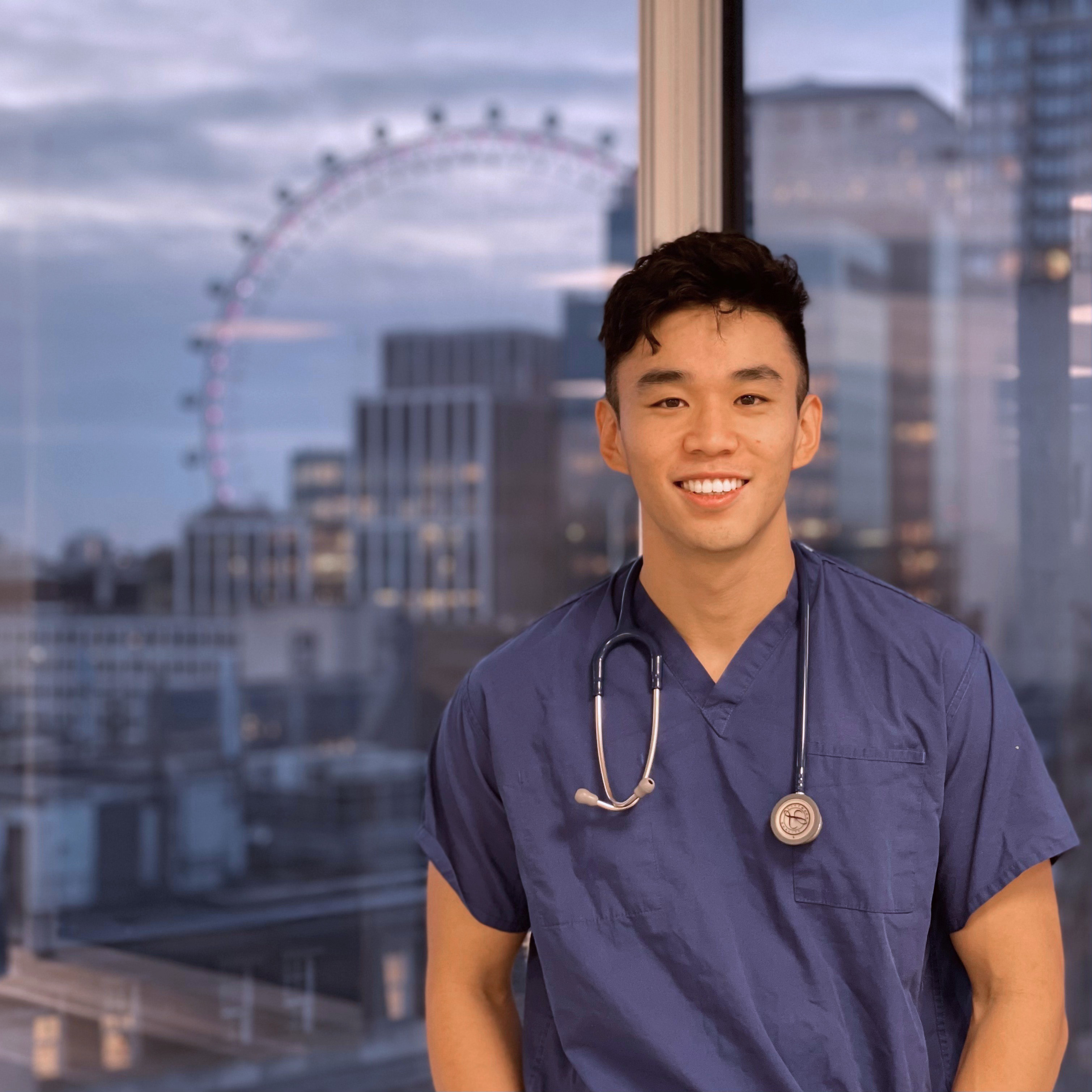 Brian Wang in front of a window with the London Eye in the distance