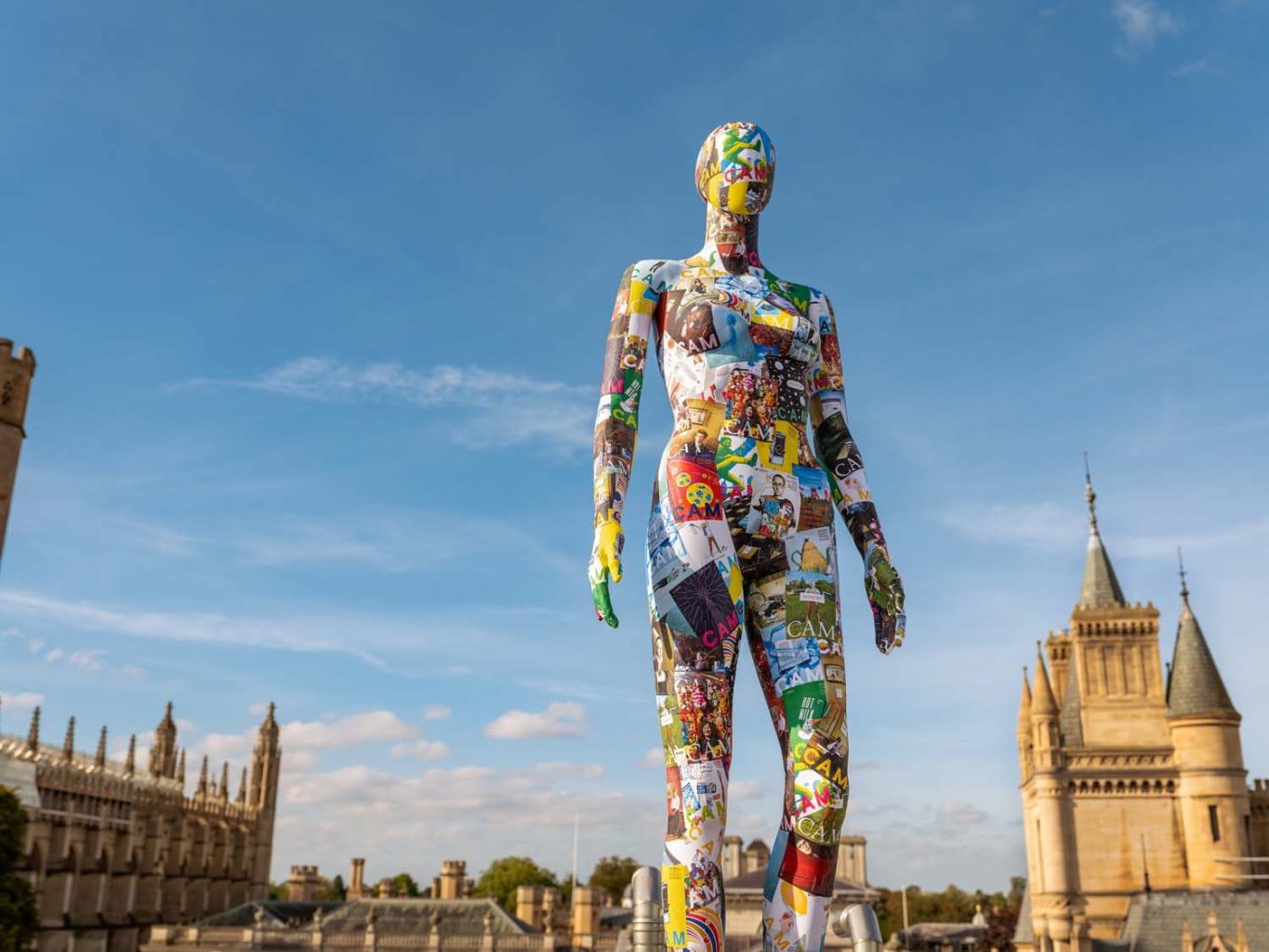 The CAM mannequin stands against a blue sky.
