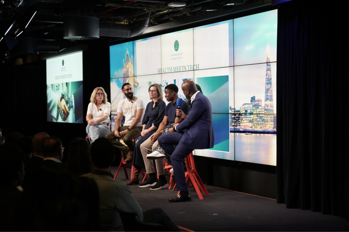 Panellists from the Cambridge Medical Graduates' Society 'Health Meets Tech' event sit in a row on stage