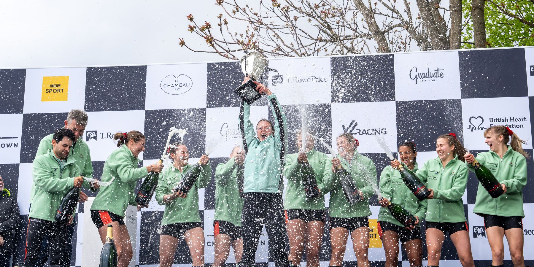 Blue Boat crews celebrate on the podium after winning The Boat Race 2025