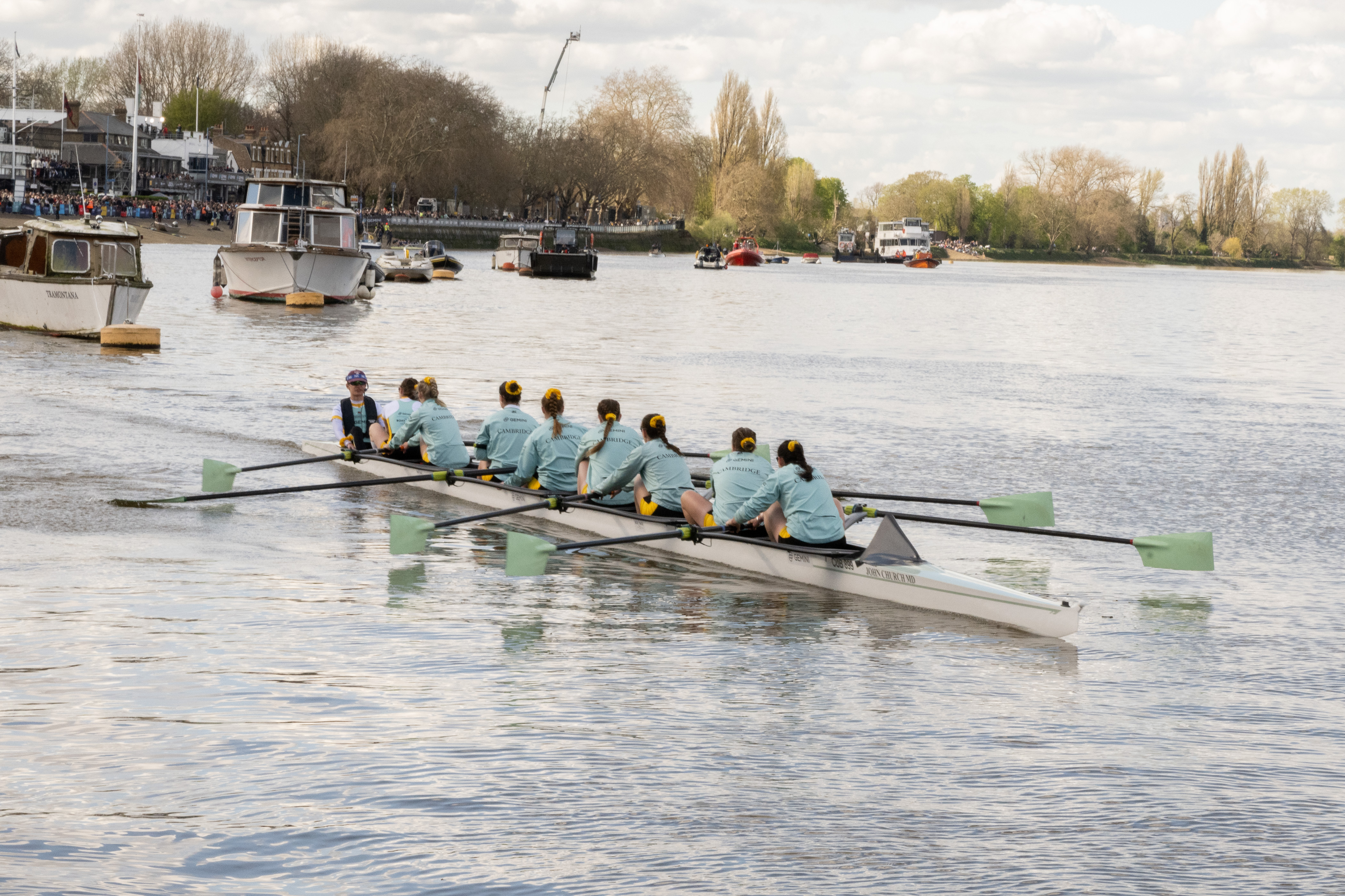 Ladies boat race team on the water preparing for their race.