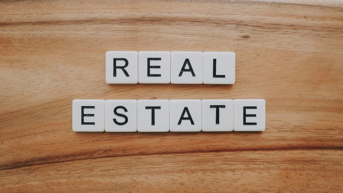 The words 'Real Estate' spelt out with letter tiles