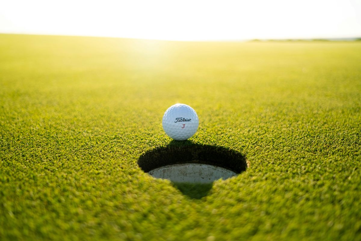 A golf ball on the edge of the hole