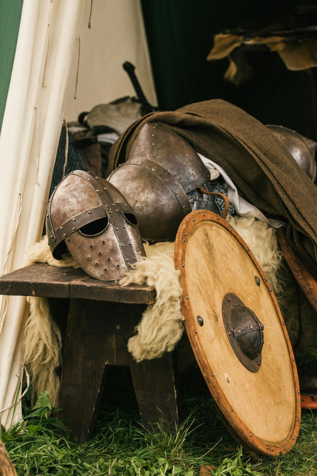 Medieval helmet and shield rest on a table