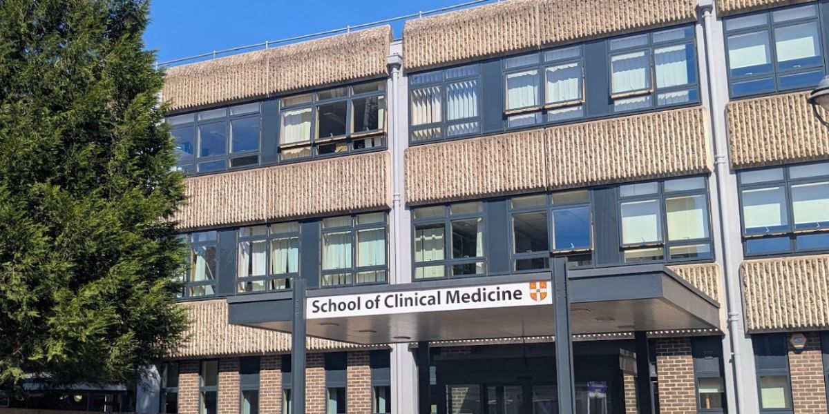 The front of the School of Clinical Medicine building on a sunny day.