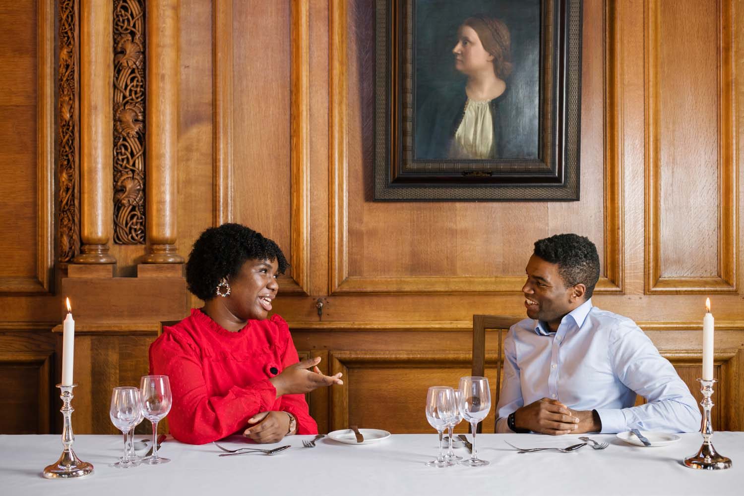 Okechukwu Nzelu and Aiseosa Eweka-Okera talking at a table
