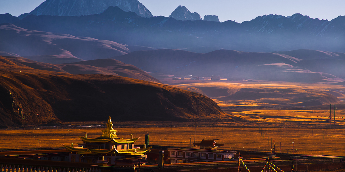 Panoramic view of Tongpan Amdo Gansu, with golden brown sands with stony mountains in the background