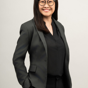 Dr Valerie Yang wearing a dark grey blazer and smiling.