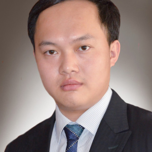 A photograph of Dr Zhao Ding wearing a suit and tie.