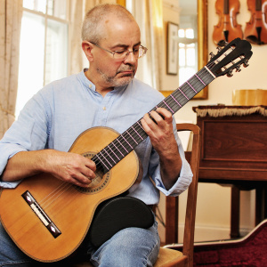 Picture of Ian Cross holding a guitar
