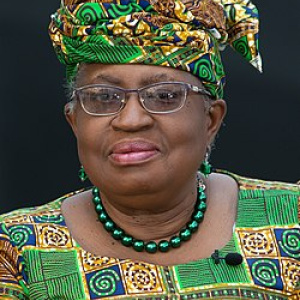 Photo of Okonjo-Iweala, dressed in traditional African dress in green yellow and black blocks