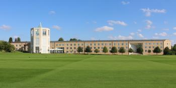 Long shot of the Moller Institutre across a very tidy green
