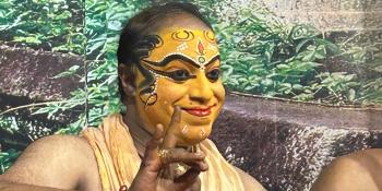 Tribe member with full traditional wear and makeup