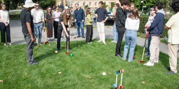 Group of people playing croquet