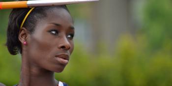Phyllis Agbo dressed in Team GB kit, holding a javelin and looking to her left.