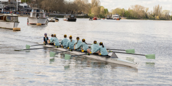 Ladies boat race team on the water preparing for their race.