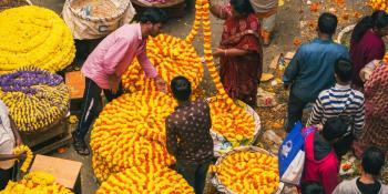people standing around a flower stall in Bangalore