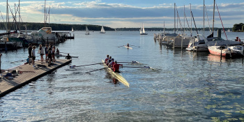 Rowing on a lake, surrounded by moored boats