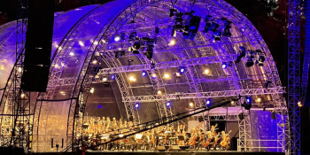 Lit up stage with an Orchestra playing