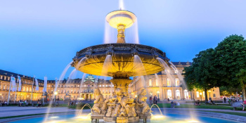A fountain lit up at night in the German Town of Stuttgart