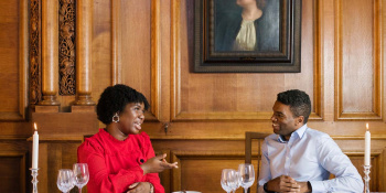 Okechukwu Nzelu and Aiseosa Eweka-Okera talking at a table