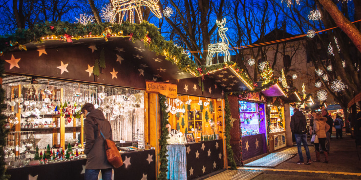 Festive market stalls being visited by the public.