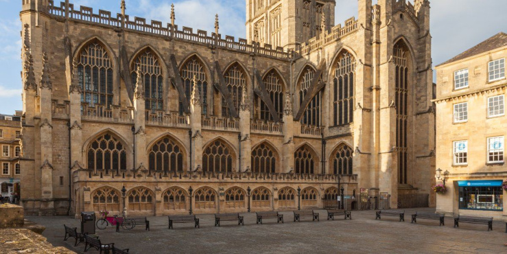 Photo shows Bath Abbey under a blue sky