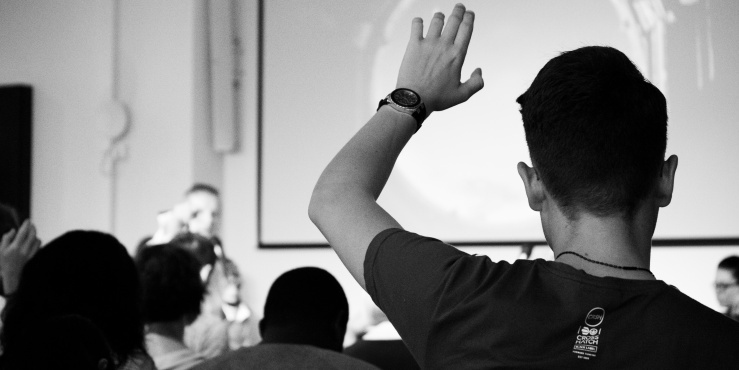 man with his hand up