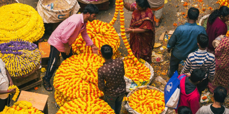 people standing around a flower stall in Bangalore