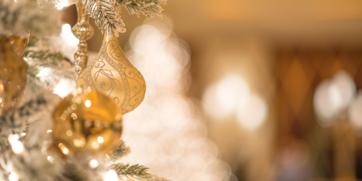 Gold Christmas ornament on a tree