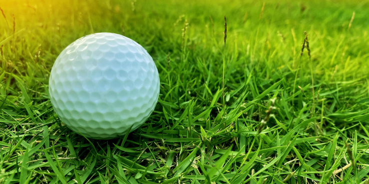 Golf ball on a grass area of golf course