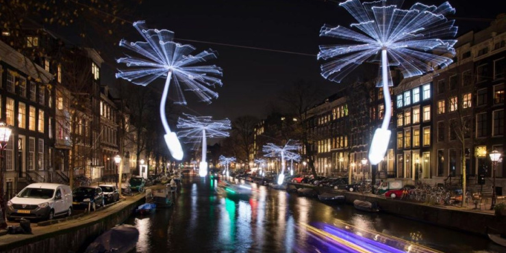Festival lights appear in the Amsterdam night sky