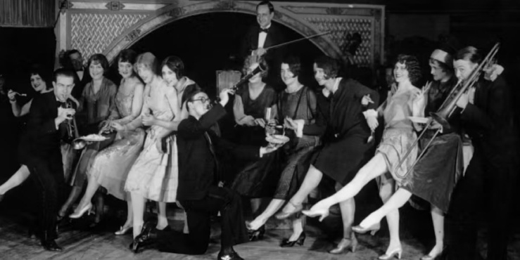 Black and White photo of people dancing and playing instruments in a jazz club