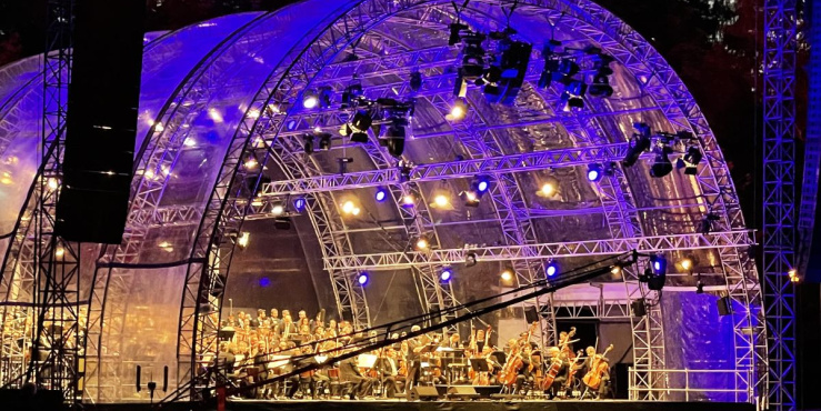 Lit up stage with an Orchestra playing