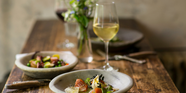 wine glass and small plates of food
