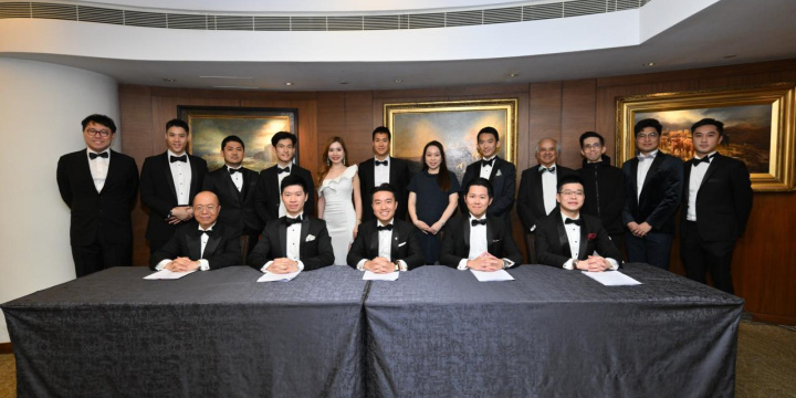The committee in black tie posing for a formal photo