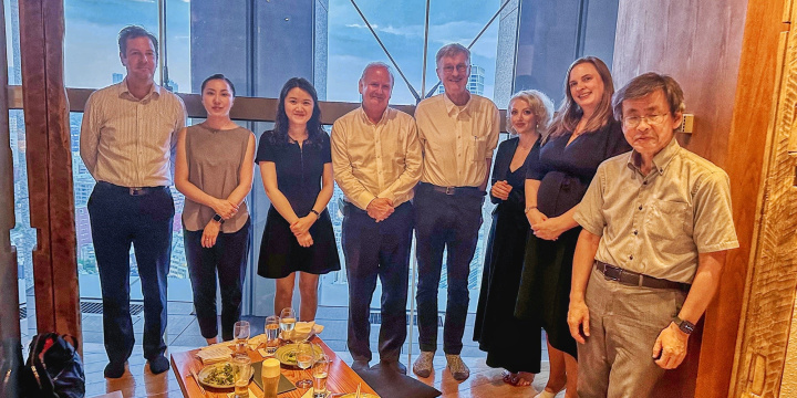 Group of people in business attire stood in a Japanese dining roomGroup of people in business attire stood in a Japanese dining