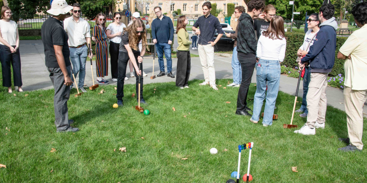 Group of people playing croquet
