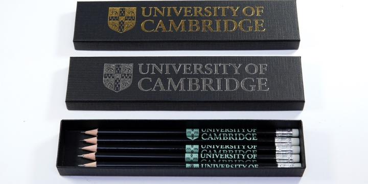 Black lids with university logo and a black box containing University branded black pencils