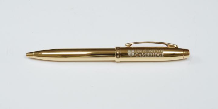 Gold pen with University branding