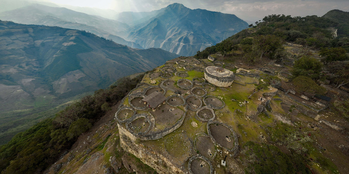 Aerial view of Kuelap ruins with circular stone structures on a mountain ridge