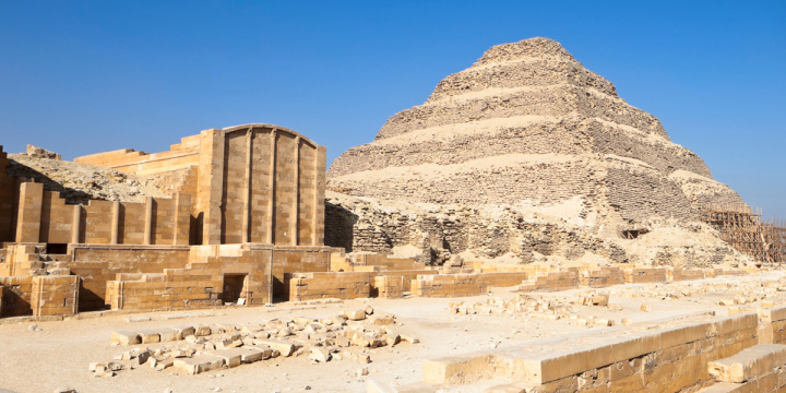 Step pyramids in Egypt sat under clear blue sky