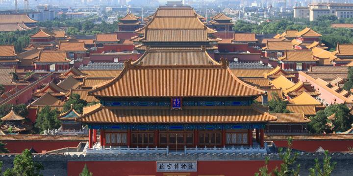 Forbidden City of China, orange roofs stretching out with the city in the background