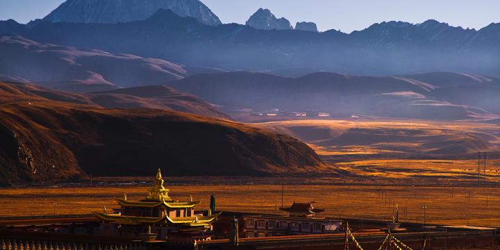 Panoramic view of Tongpan Amdo Gansu, with golden brown sands with stony mountains in the background
